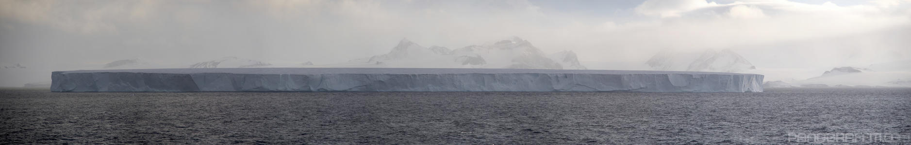 A Small Frozen Village Floats By - At the dimensions of a small village, this iceberg is only showing 10% of its size above water
