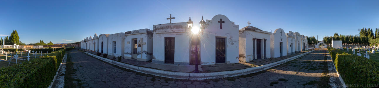 Graveyard in El Calafate - The sun shines between buildings at a graveyard in El Calafate